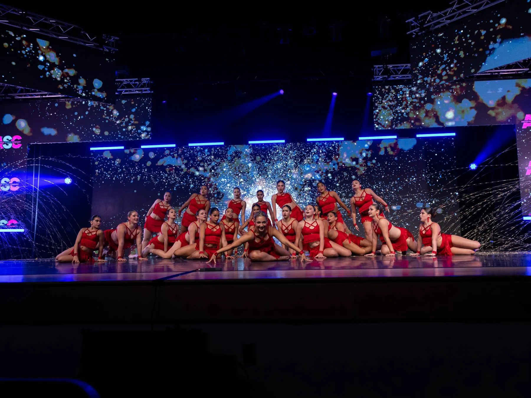 The finale: the whole Studio Company in red fringe, seated across the full stage